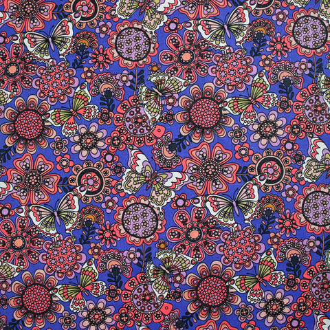 Coral butterfly print cotton with purple background by the meter